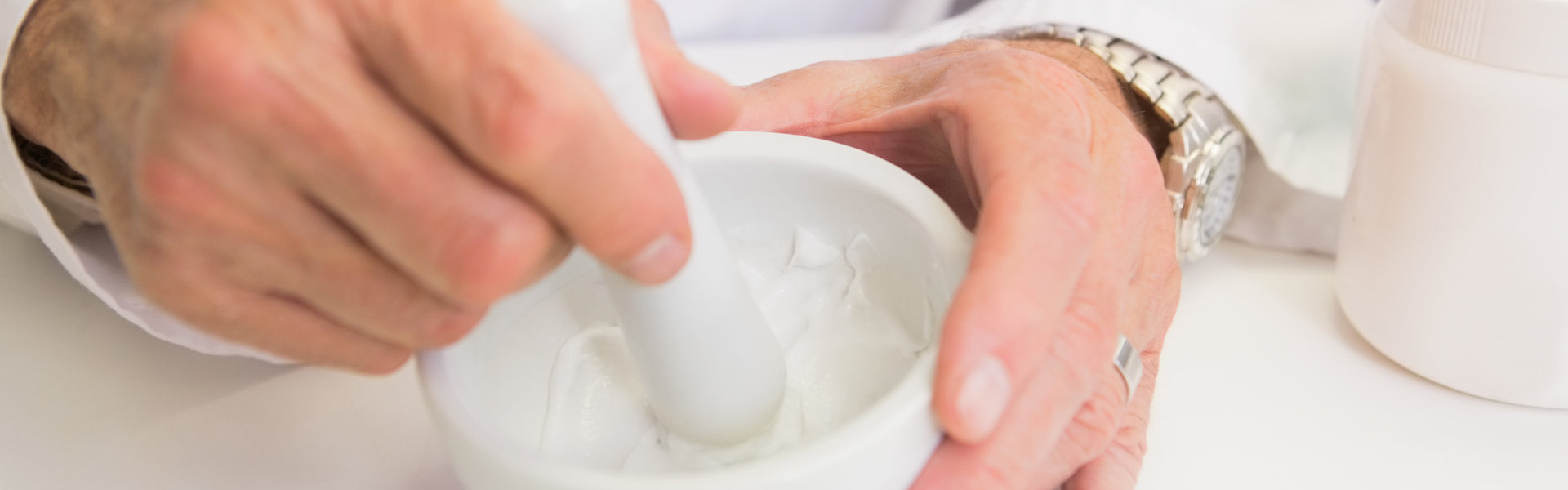 Close up of pharmacist mixing medicine in the pharmacy