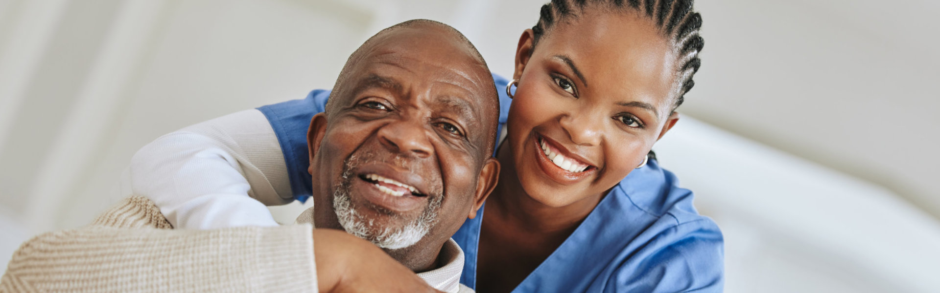 Senior man, nurse and hug portrait on a sofa for support